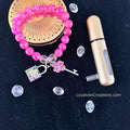 Hot pink crackle bead bracelet with multicolour rhinestone padlock and pink heart key charms flat lay on dark background - LoyatobsCreations.com