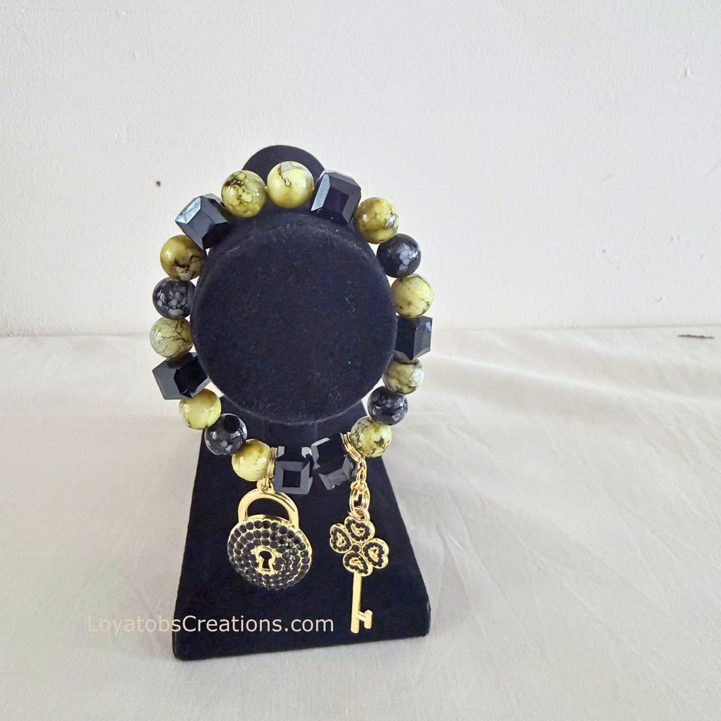 Lime and black cube bead bracelet with gold pavé lock and clover key charms on black jewellery stand - LoyatobsCreations.com