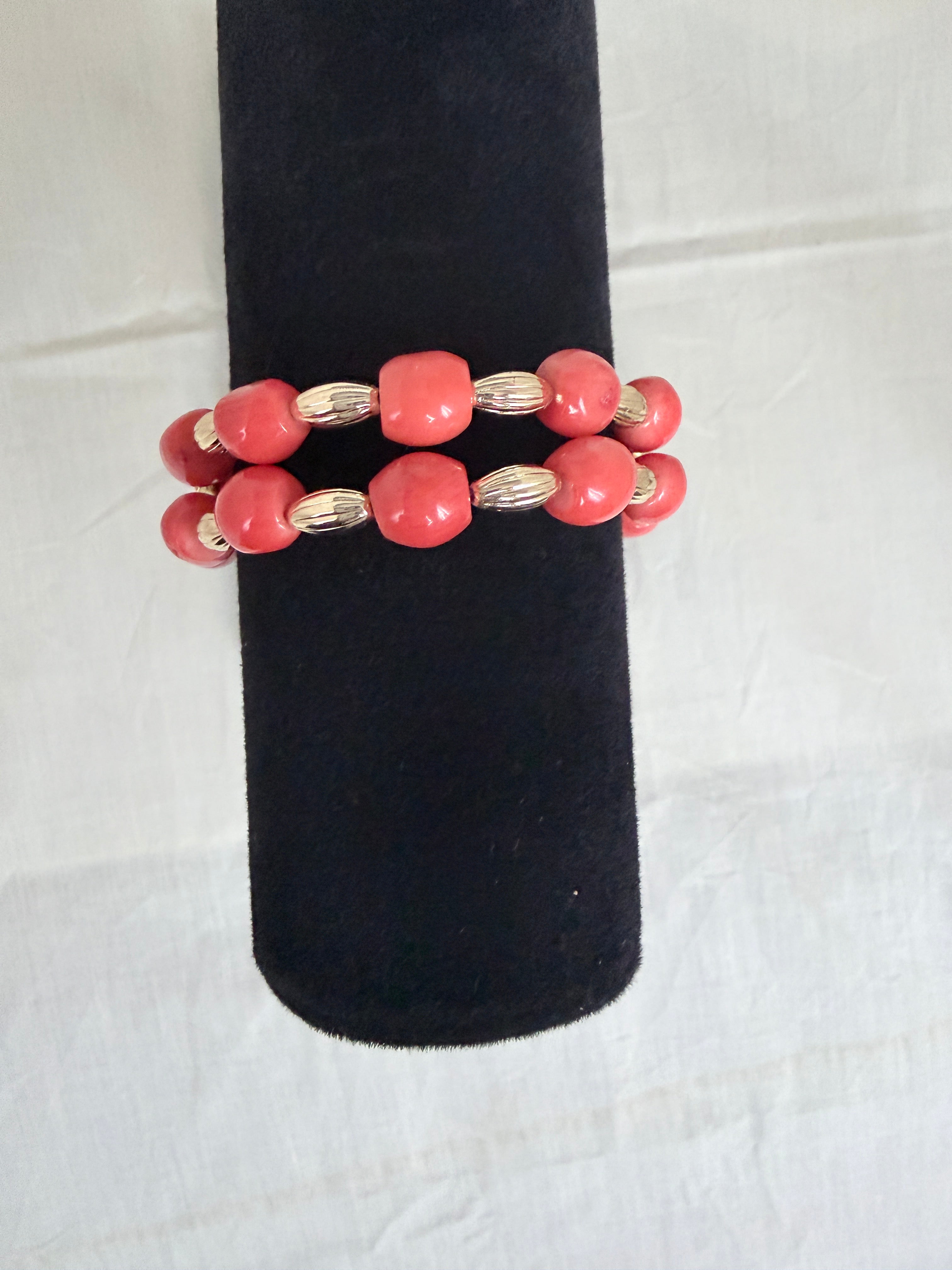 "Barrel coral two-row bracelet on black velvet stand showing front view and double row bead detail"