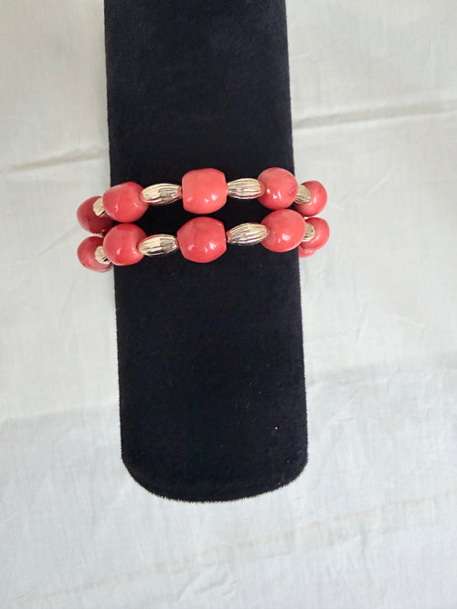 "Barrel coral two-row bracelet on black velvet stand showing front view and double row bead detail"