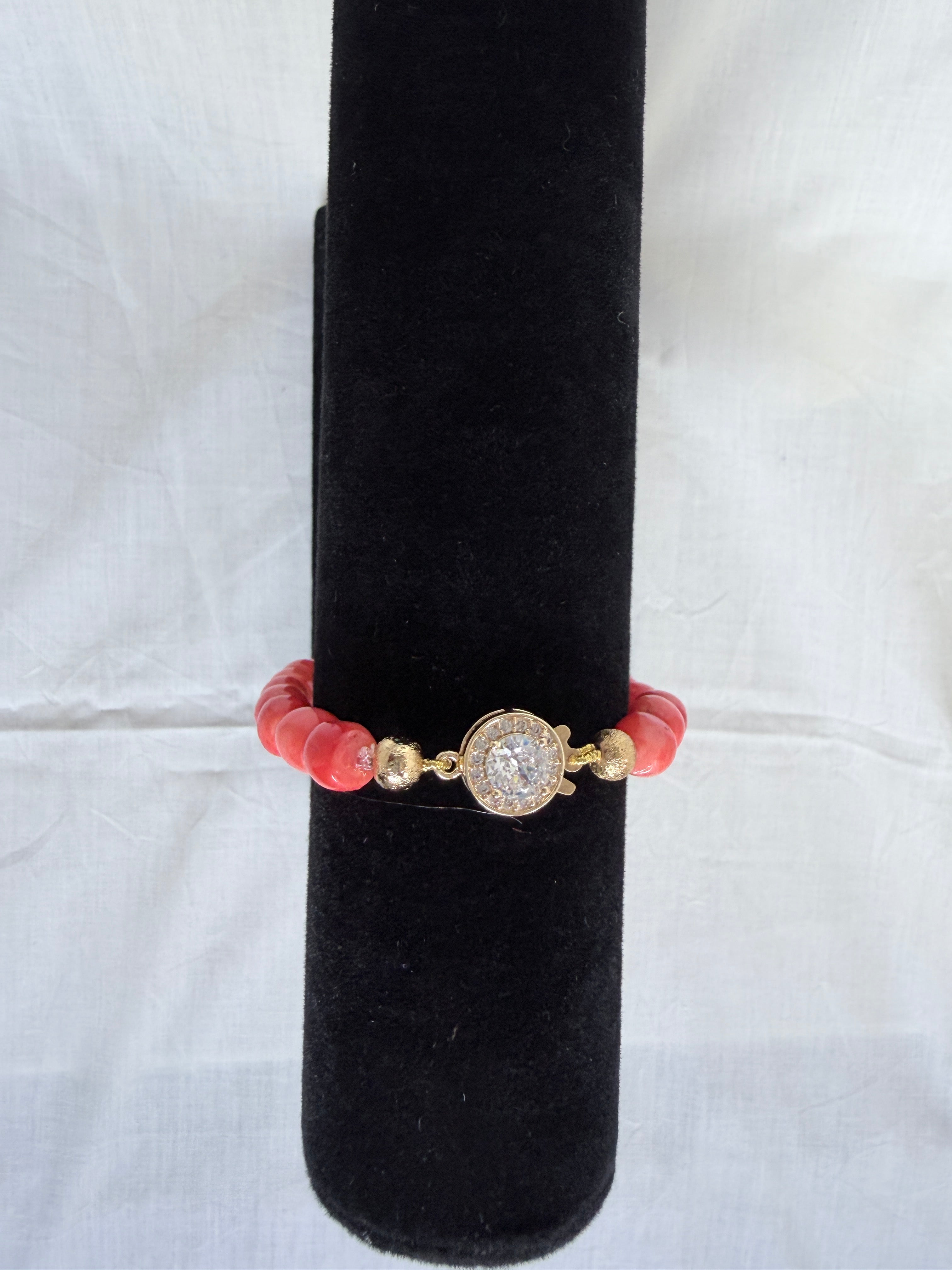 "Mixed coral barrel bracelet on black velvet stand showing sparkling round CZ fish hook clasp with gold rondelle accessories"