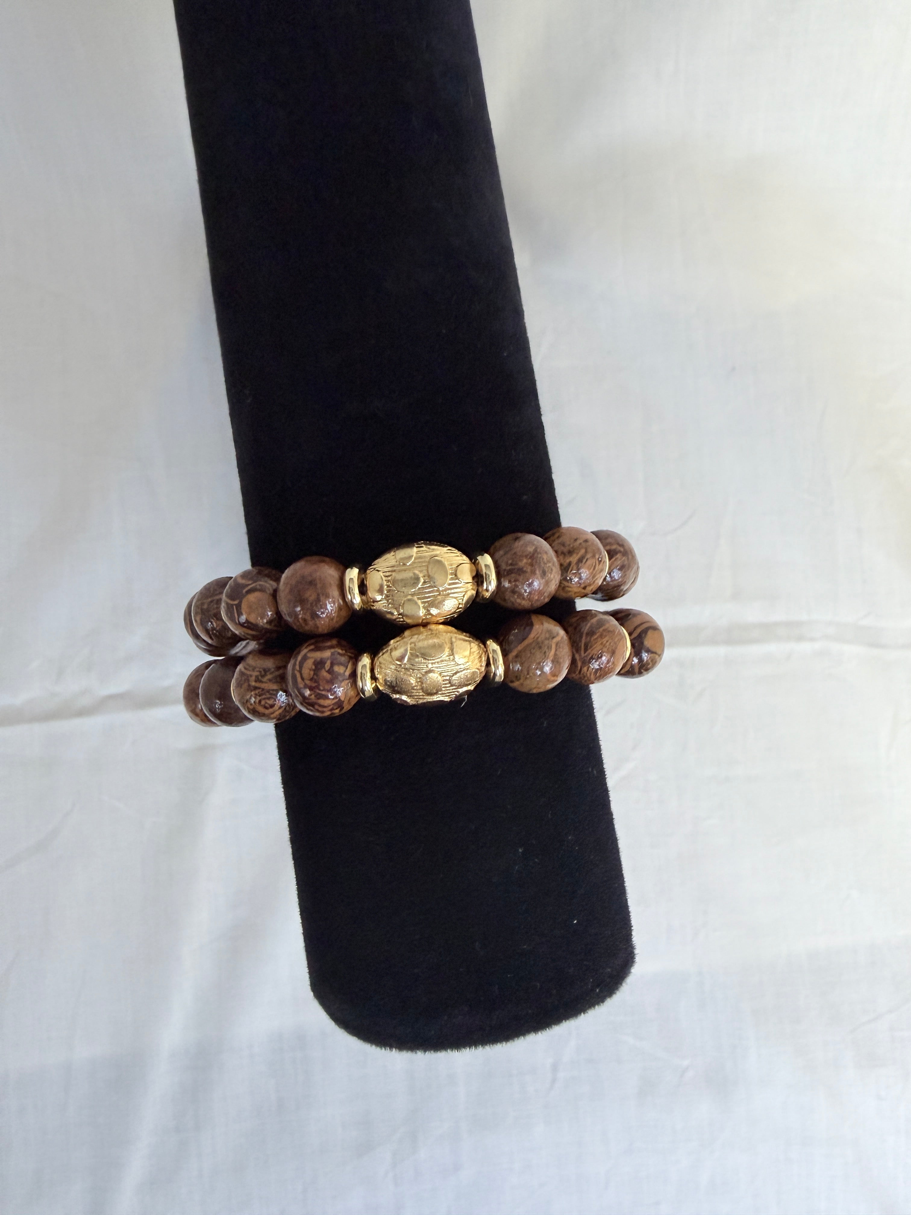 "Two elephant skin jasper bracelets stacked on black velvet stand showing how they look layered together"