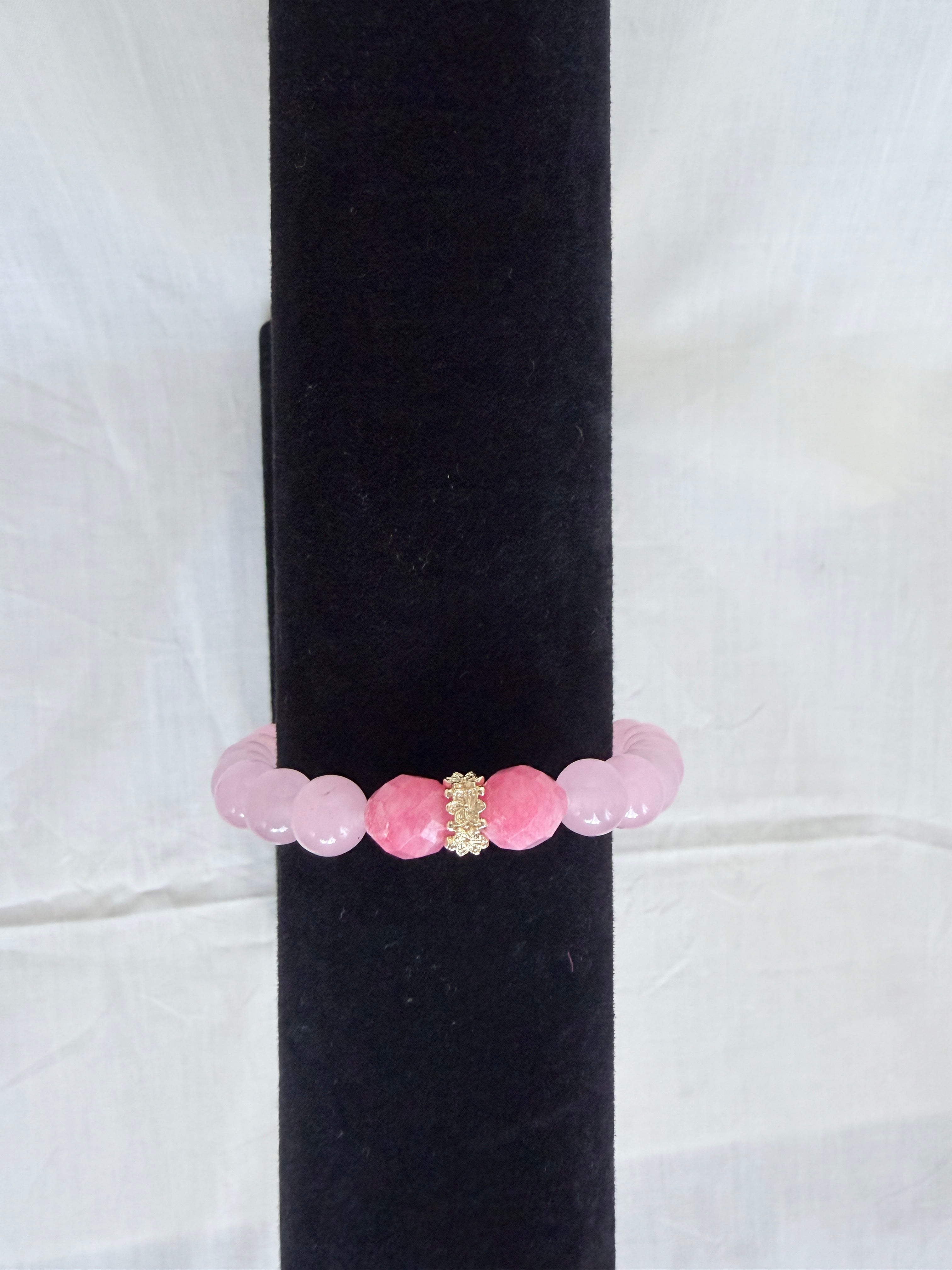 "Pink jade and candy bracelet on black velvet stand showing close-up of sparkling gold rondelle centrepiece with soft blush pink jade beads"