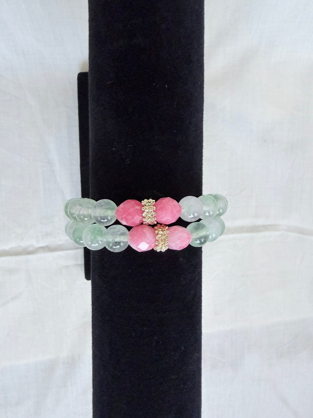 "Two mint green jade and candy bracelets stacked on black velvet stand showing how they look layered together with pink candy beads and gold CZ rondelles"