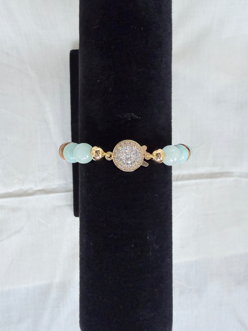  "Jasper and aqua agate bracelet on black velvet stand showing close-up of sparkling CZ round fish hook clasp with aqua agate beads"
