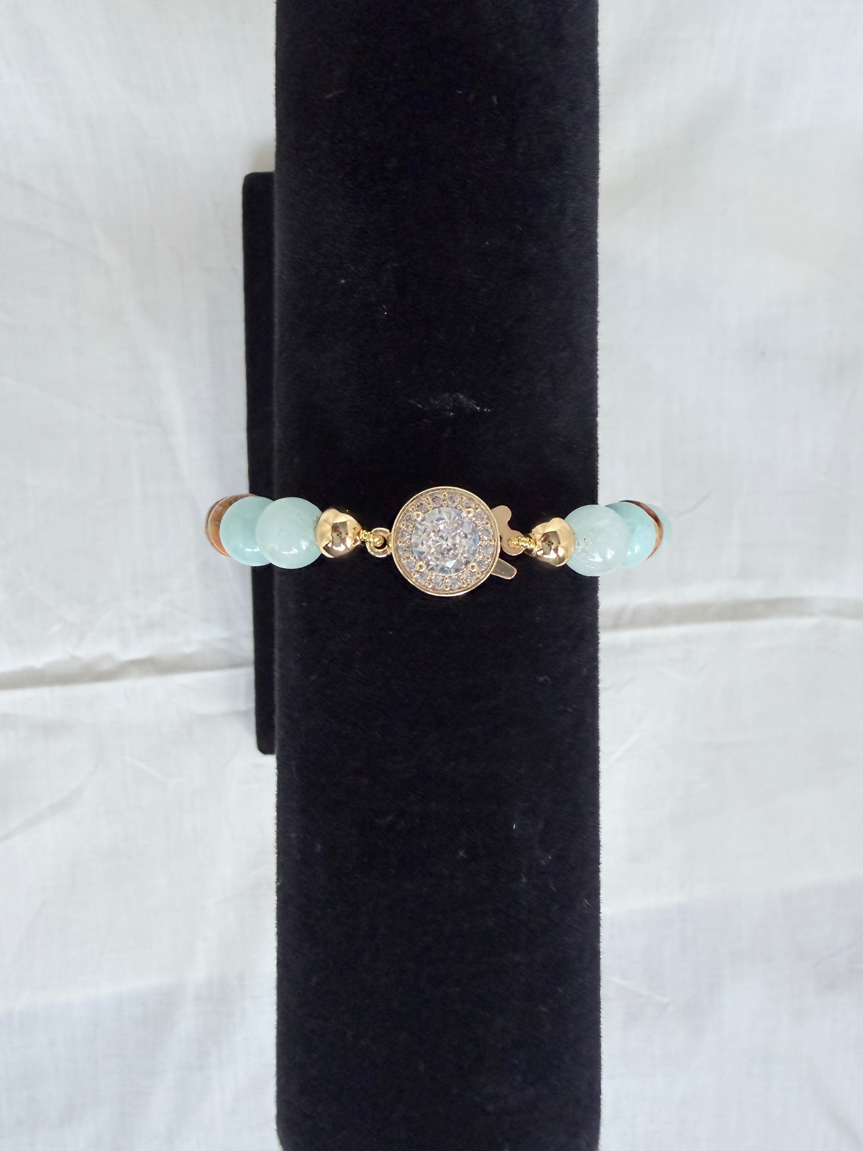  "Jasper and aqua agate bracelet on black velvet stand showing close-up of sparkling CZ round fish hook clasp with aqua agate beads"