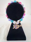 Cupid's Arrow Charm Bracelet on black velvet stand showing gold rhinestone heart and arrow charm with multicolour pastel pink teal purple and lavender beads