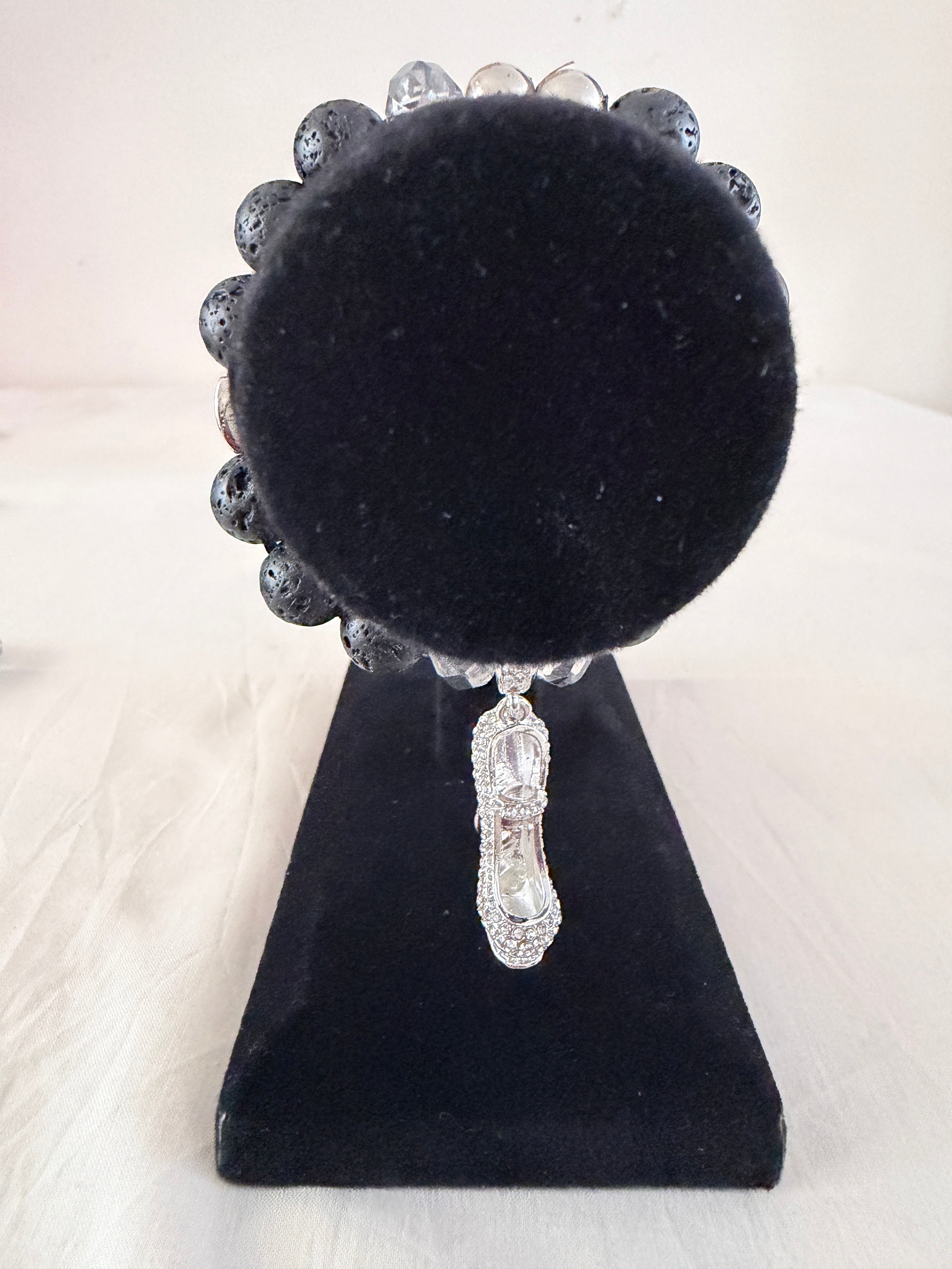 She Walks in Beauty Charm Bracelet on black velvet stand showing silver rhinestone stiletto heel charm with black lava stone and clear crystal beads