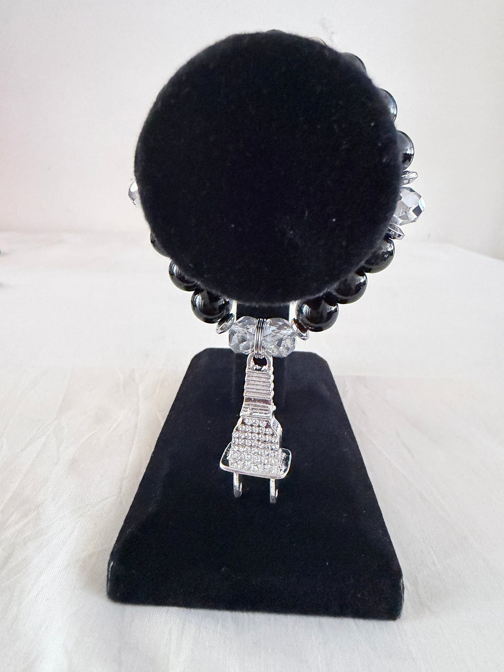 Power Up Charm Bracelet on black velvet stand showing silver rhinestone plug charm with black and clear crystal beads