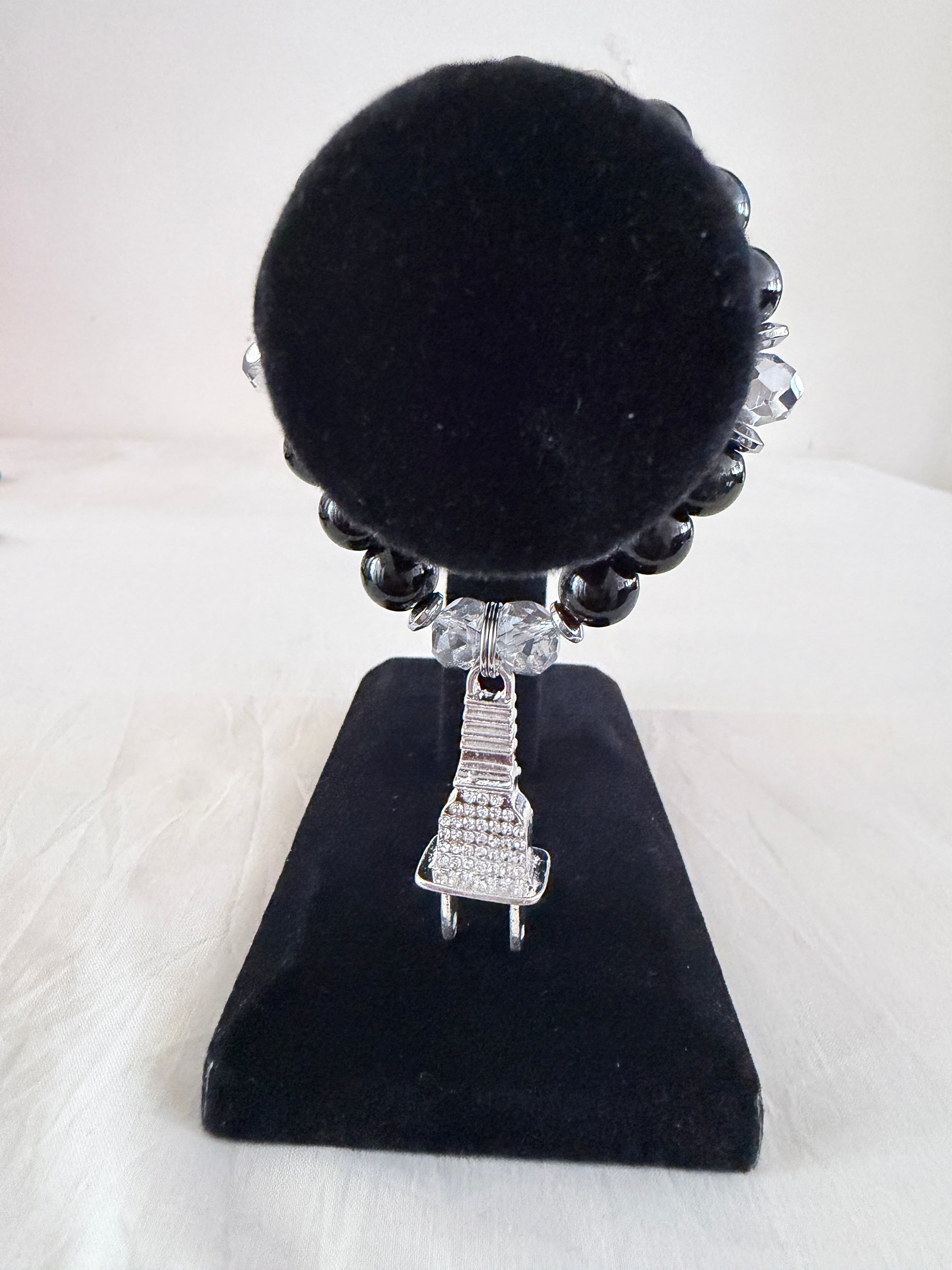 Power Up Charm Bracelet on black velvet stand showing silver rhinestone plug charm with black and clear crystal beads