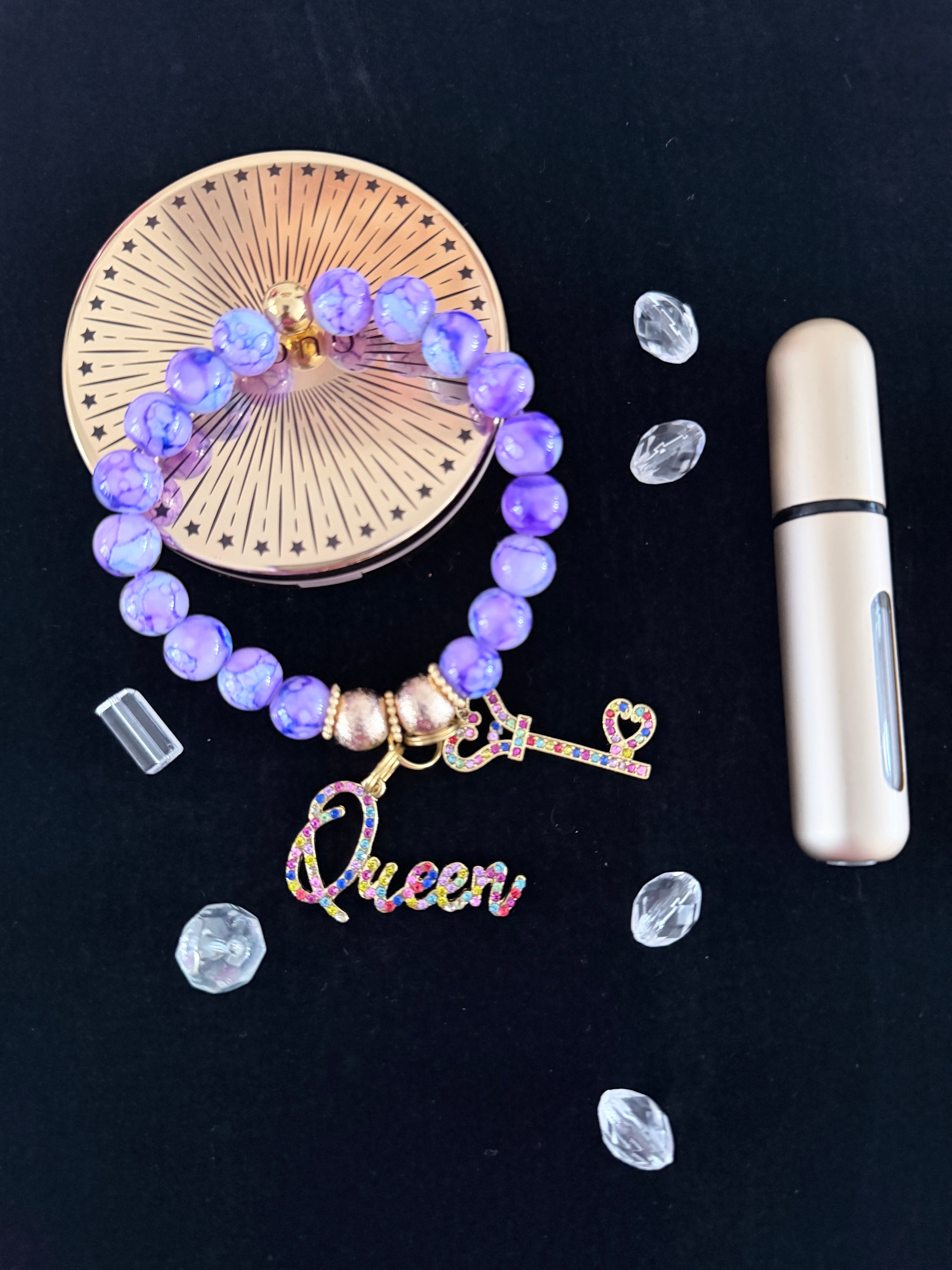 Purple marble bead bracelet with multicolour rhinestone Queen and key charms flat lay on dark background - LoyatobsCreations.com