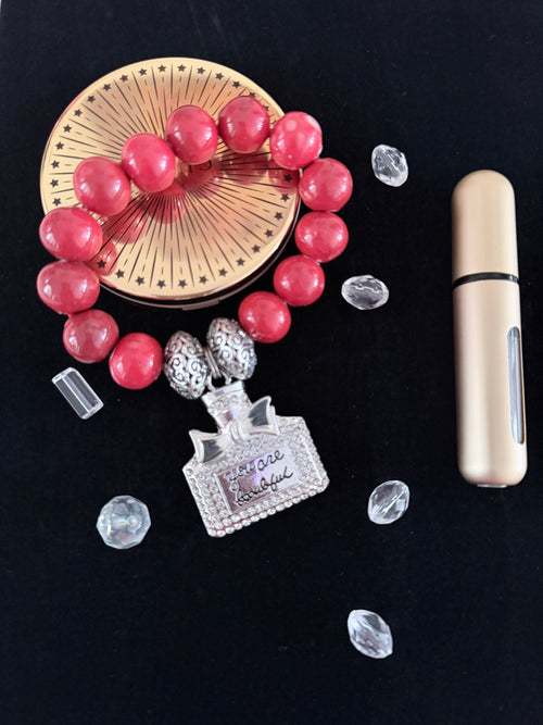 Coral ceramic bead bracelet with silver rhinestone You Are Beautiful perfume bottle charm flat lay on dark background - LoyatobsCreations.com