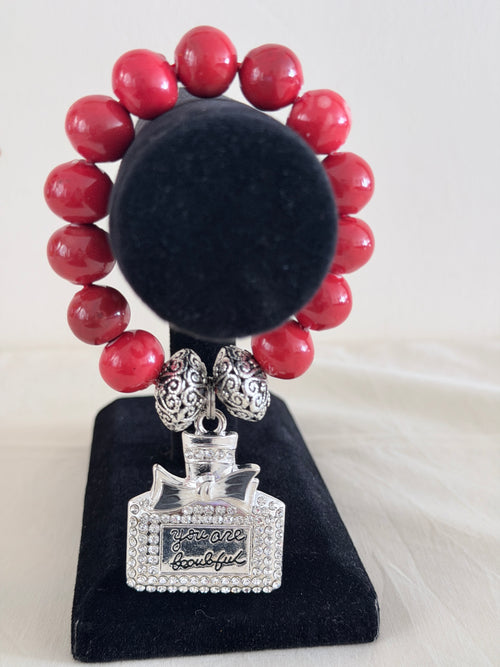 Coral ceramic bead bracelet with silver rhinestone You Are Beautiful perfume bottle charm on black jewellery stand - LoyatobsCreations.com