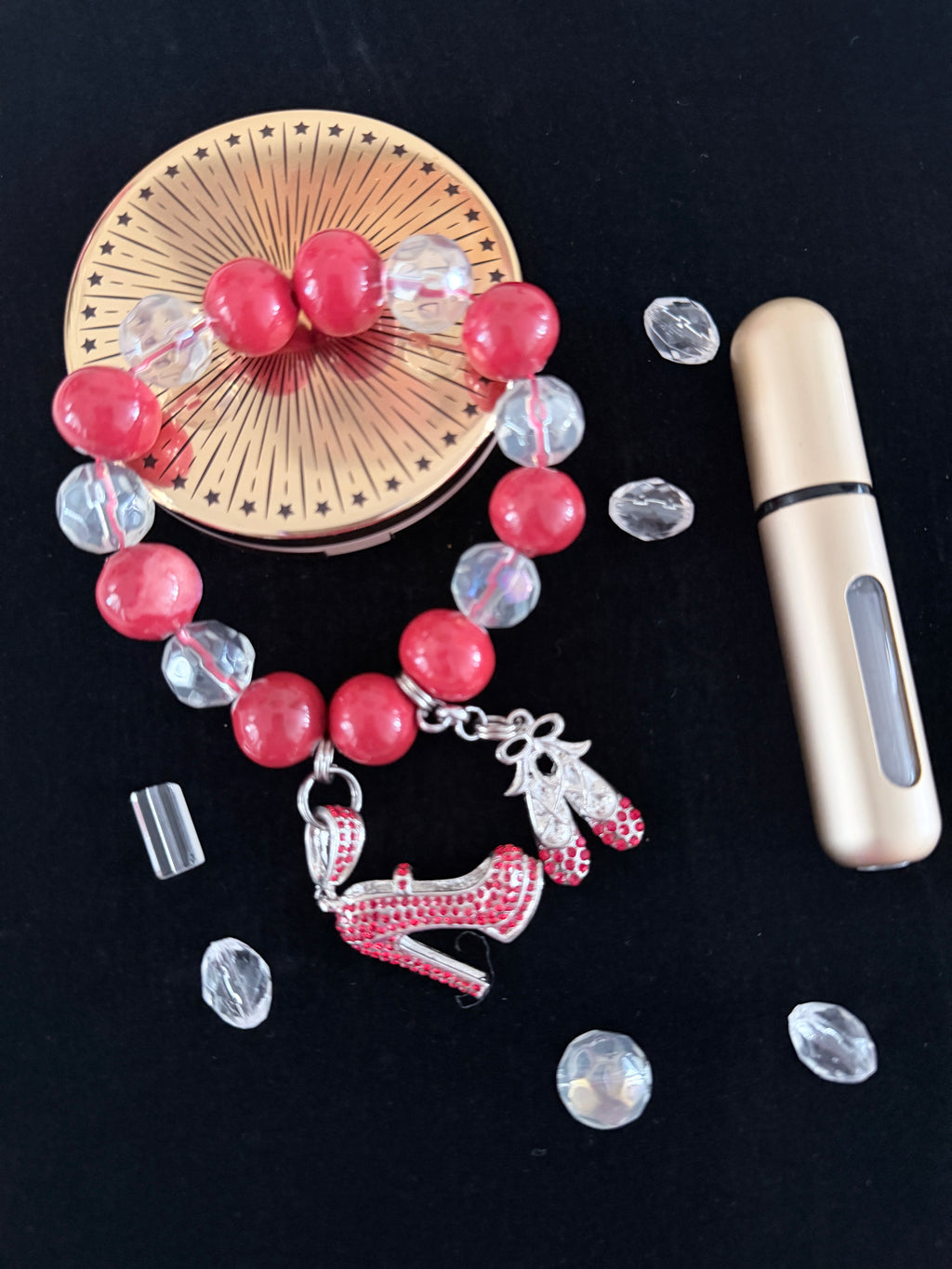 Coral pink and crystal bead bracelet with silver rhinestone stiletto and ballet slipper charms flat lay on dark background - LoyatobsCreations.com