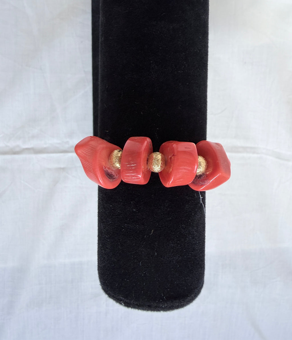 "Coral barrel bracelet on black velvet stand showing sparkling CZ centrepiece clasp with gold plated accessories"