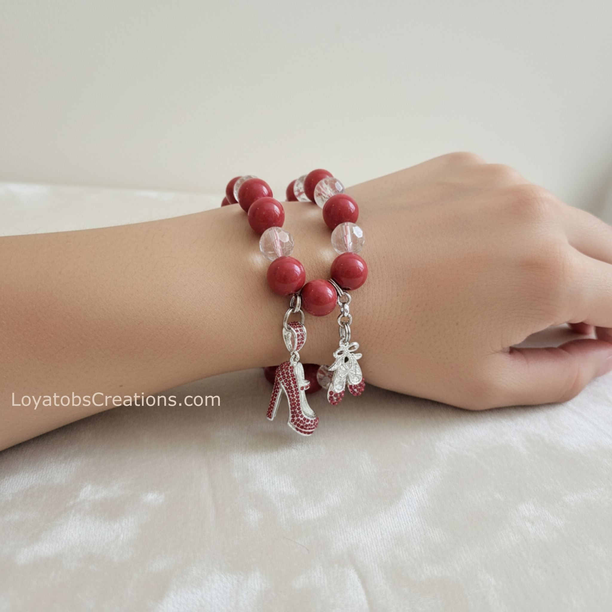 Coral pink and crystal bead bracelet with silver rhinestone stiletto and ballet slipper charms worn on wrist - LoyatobsCreations.com