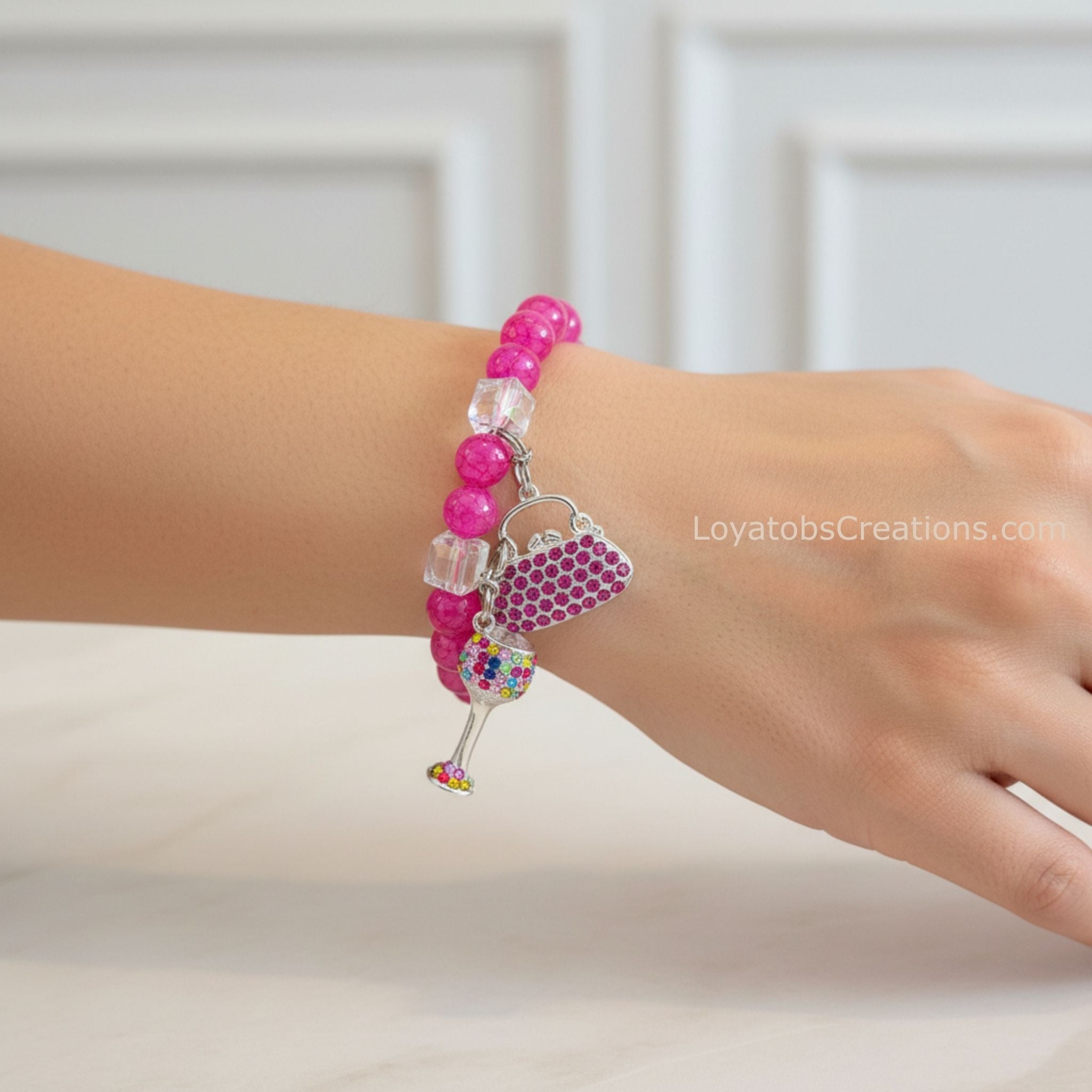 Hot pink crackle bead bracelet with pink rhinestone handbag and multicolour wine glass charms worn on wrist - LoyatobsCreations.com