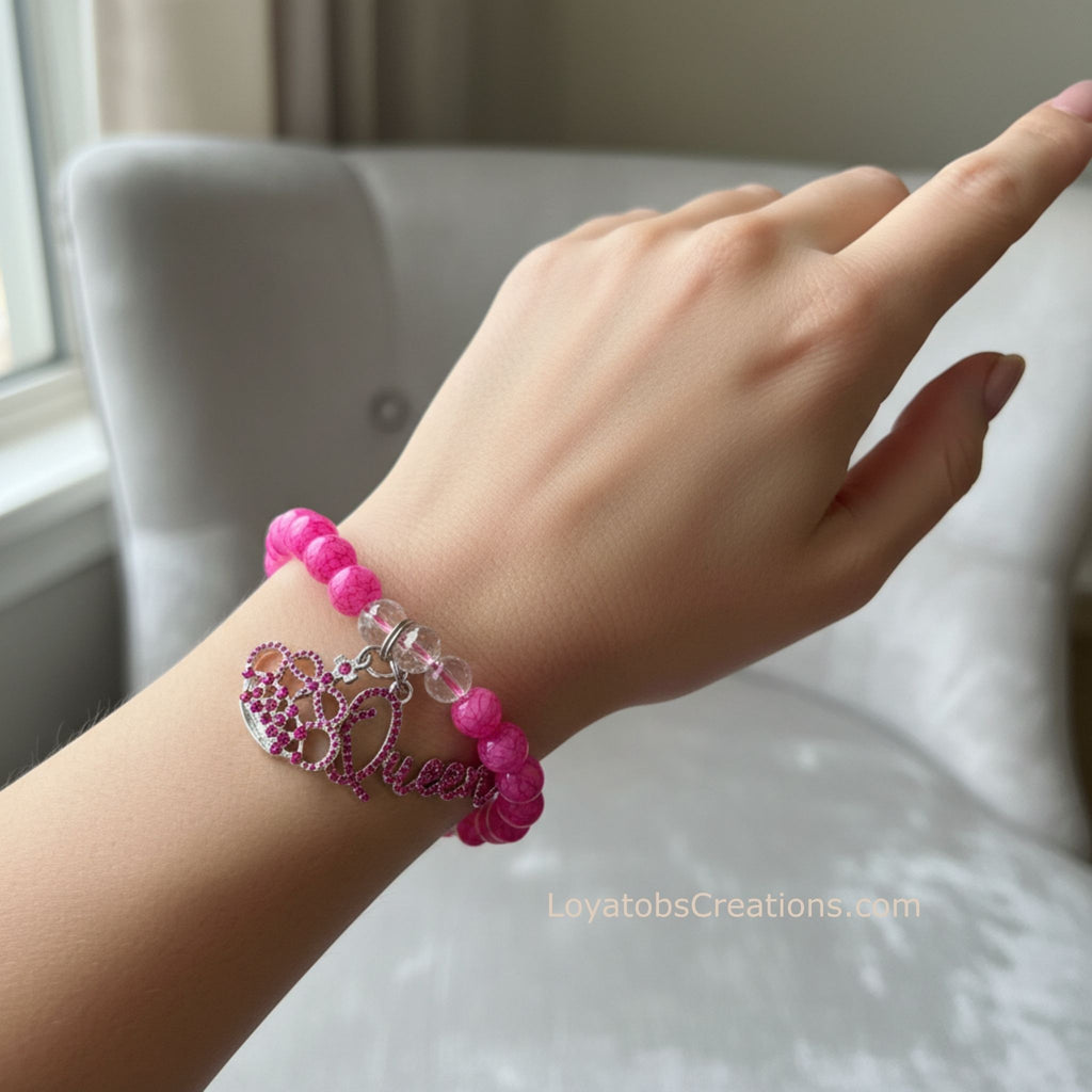 Hot pink crackle bead bracelet with pink rhinestone crown and Queen script charms worn on wrist - LoyatobsCreations.com