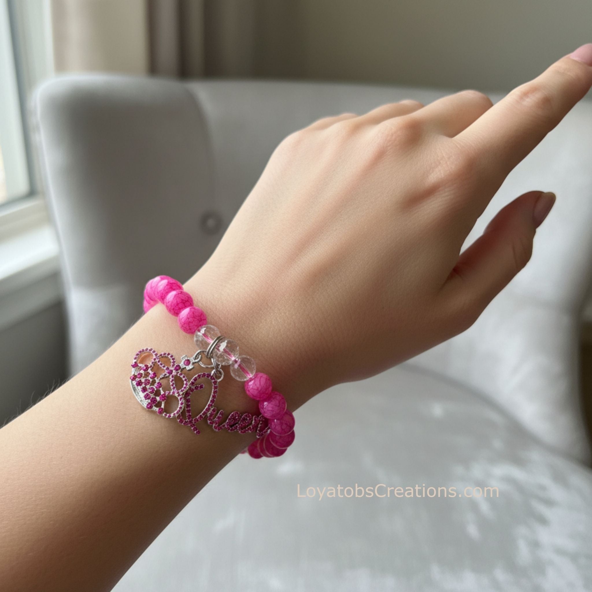 Hot pink crackle bead bracelet with pink rhinestone crown and Queen script charms worn on wrist - LoyatobsCreations.com